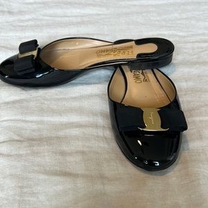 Ferragamo Black patent leather slides with gold detail
